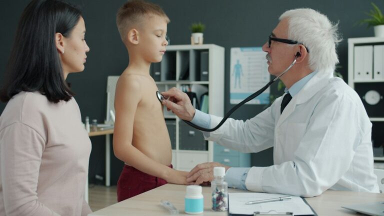Paediatric doctor examining a child during a clinic consultation